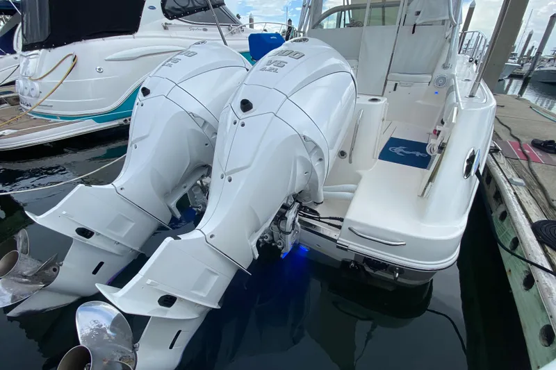 Slide: The Image of 2007 Robalo R305 Walkaround boat interior with cushioned seating and storage area. - 34