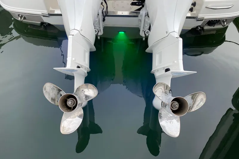 Slide: The Image of 2007 Robalo R305 Walkaround with twin outboard engines docked at marina. - 37