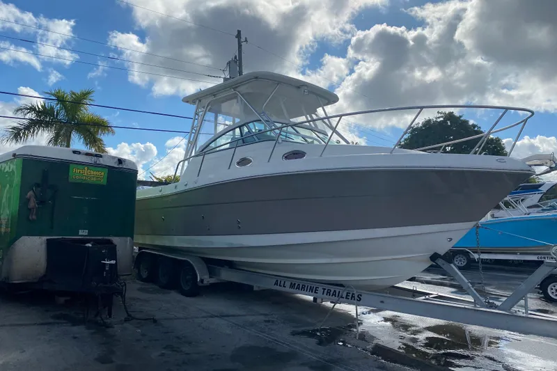Slide: The Image of 2007 Robalo R305 Walkaround boat docked with twin 300 V6 engines. - 48