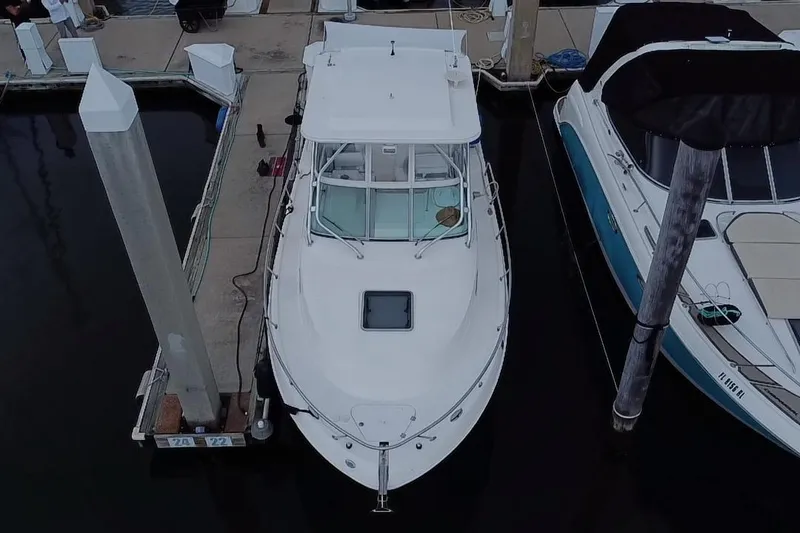 Slide: The Image of 2007 Robalo R305 Walkaround boat docked at marina, front view. - 6