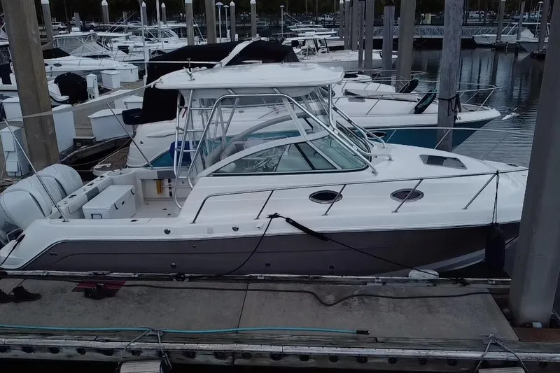 Slide: The Image of 2007 Robalo R305 Walkaround boat, aerial view of deck and cabin, docked at marina. - 8