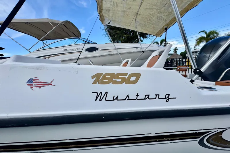 Slide: The Image of Dashboard of a 2006 Century 1850 Mustang boat with gauges and compass. - 11