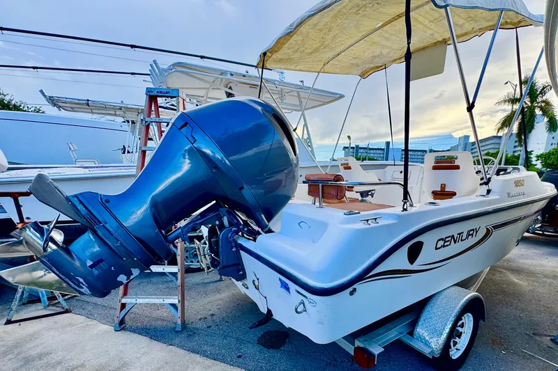 Slide: The Image of Century 1850 Mustang 2006 boat interior with brown cushioned seats and steering wheel. - 2