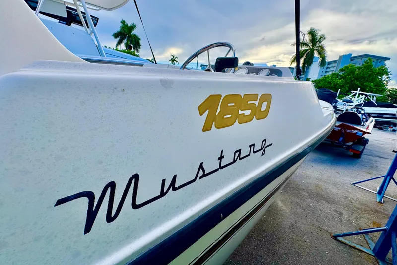 Slide: The Image of Control panel of a 2006 Century 1850 Mustang boat with throttle and switches. - 22