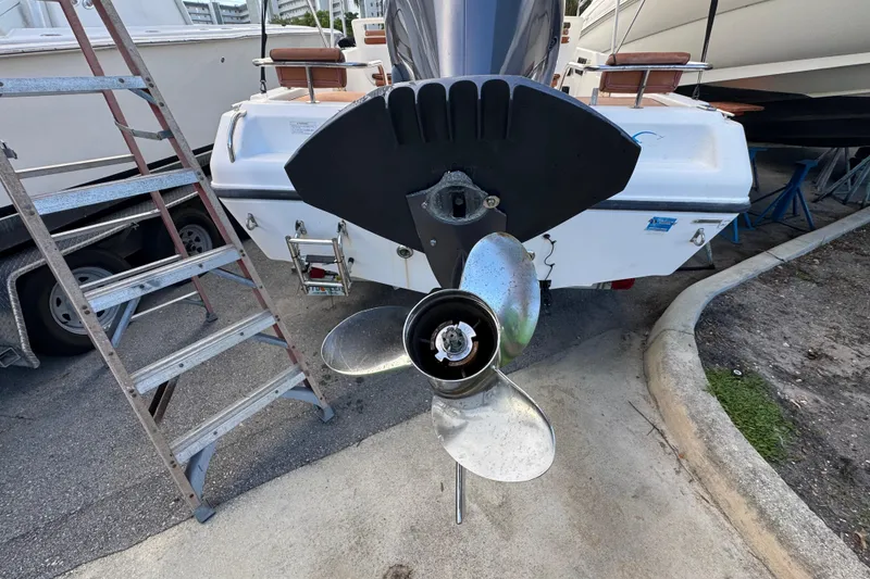 Slide: The Image of Open storage compartment on 2006 Century 1850 Mustang boat deck, with speaker and hand visible. - 25