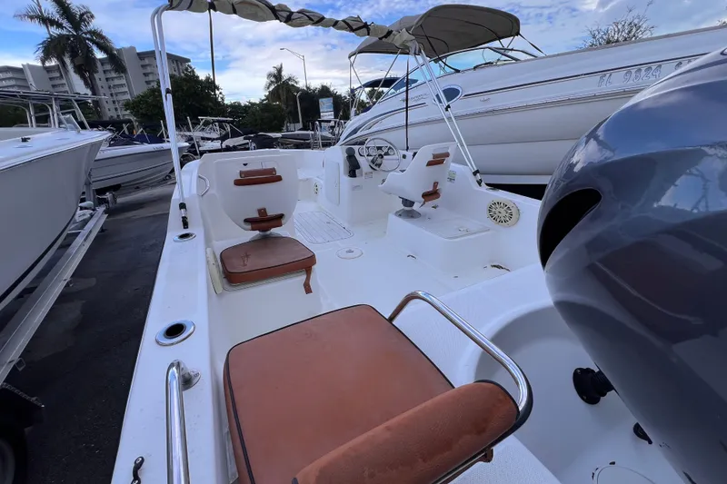 Slide: The Image of 2006 Century 1850 Mustang boat interior with seating and outboard motor. - 26