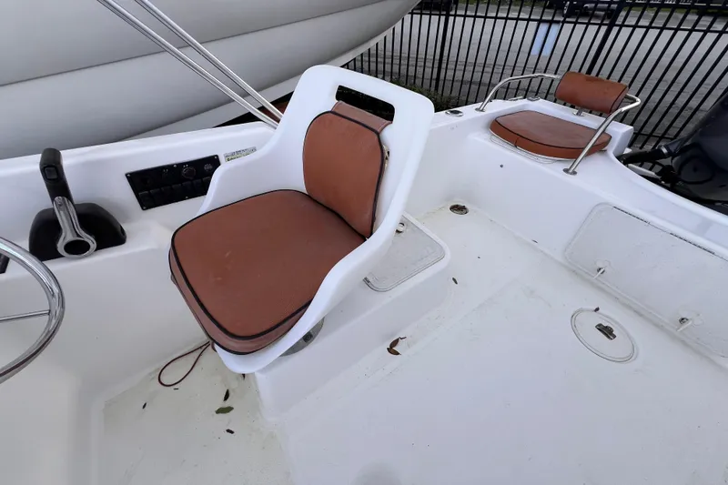 Slide: The Image of Control panel with switches and voltage display on a 2006 Century 1850 Mustang boat. - 27