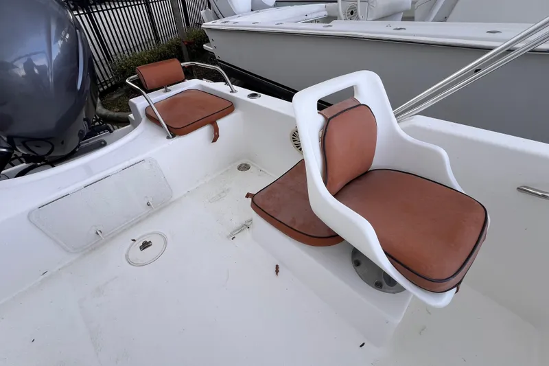 Slide: The Image of 2006 Century 1850 Mustang boat interior with seating and storage compartments. - 30