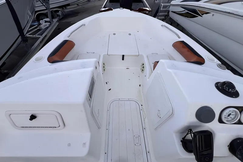 Slide: The Image of Man opening storage compartment on 2006 Century 1850 Mustang boat deck. - 33