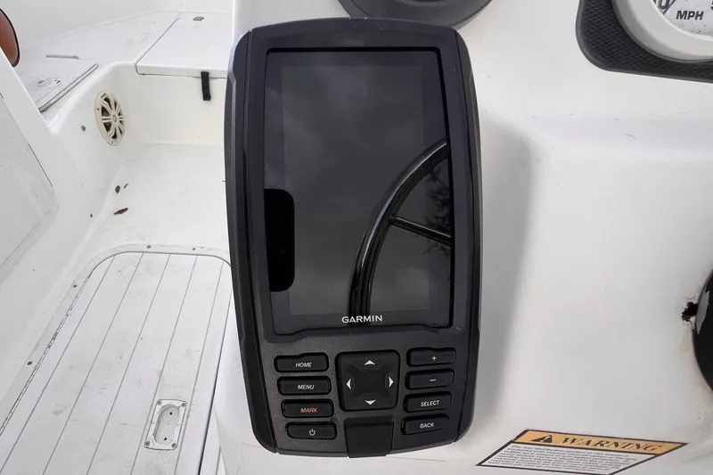 Slide: The Image of 2006 Century 1850 Mustang boat interior with brown cushioned seating. - 35