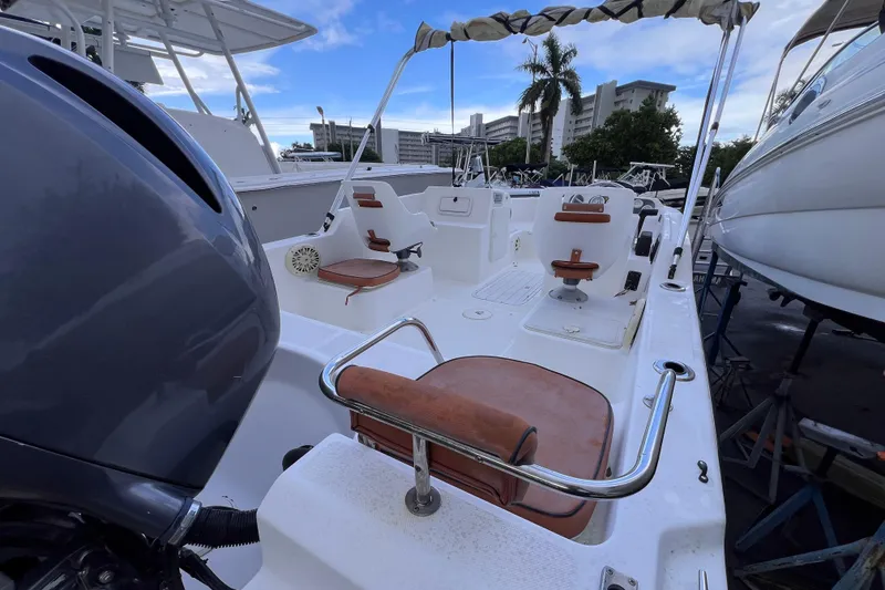 Slide: The Image of 2006 Century 1850 Mustang boat interior with tan seating and white deck. - 37