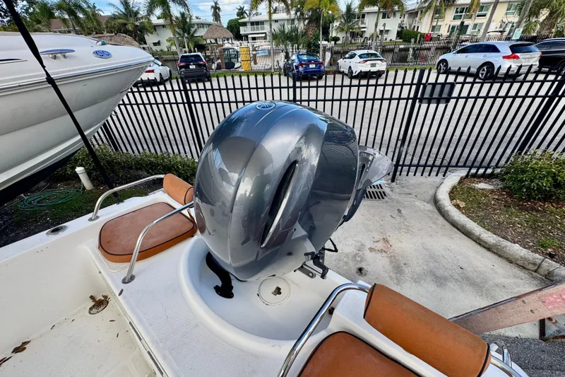 Slide: The Image of 2006 Century 1850 Mustang boat interior with brown seating and steering wheel. - 38