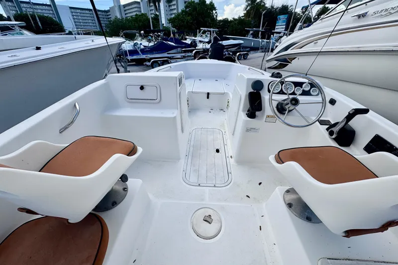 Slide: The Image of Close-up of 2006 Century 1850 Mustang boat logo on white surface. - 44