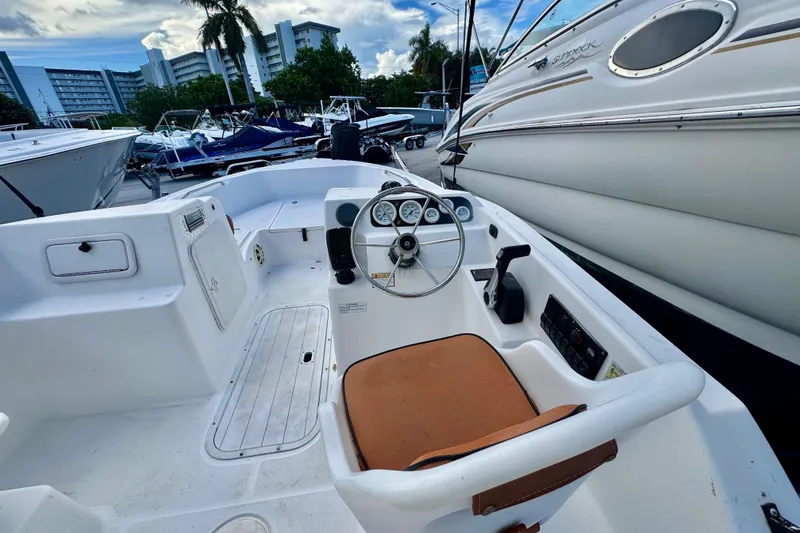 Slide: The Image of 2006 Century 1850 Mustang boat with outboard motor on trailer. - 47