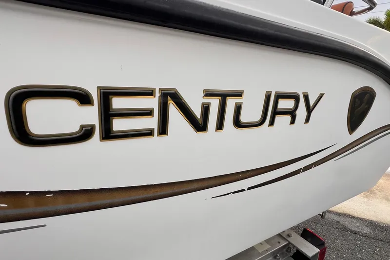 Slide: The Image of Century 1850 Mustang 2006 boat interior with brown cushioned seats and white deck. - 7