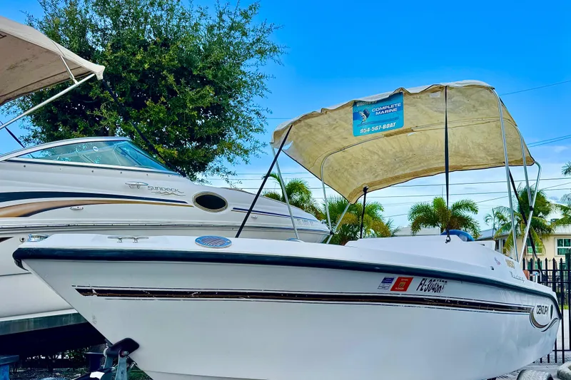 Slide: The Image of 2006 Century 1850 Mustang boat interior with white seating and control panel. - 9