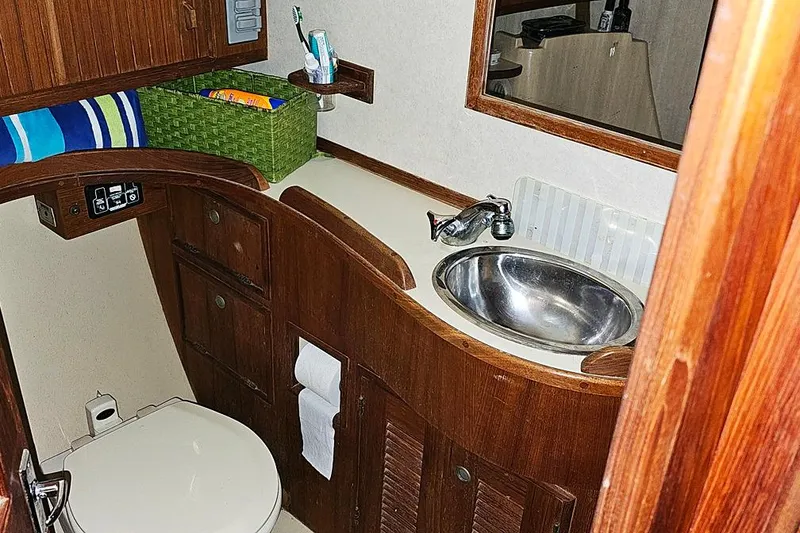 Slide: The Image of Bathroom interior of 2000 Island Packet 350 yacht with wooden cabinetry and stainless steel sink. - 13