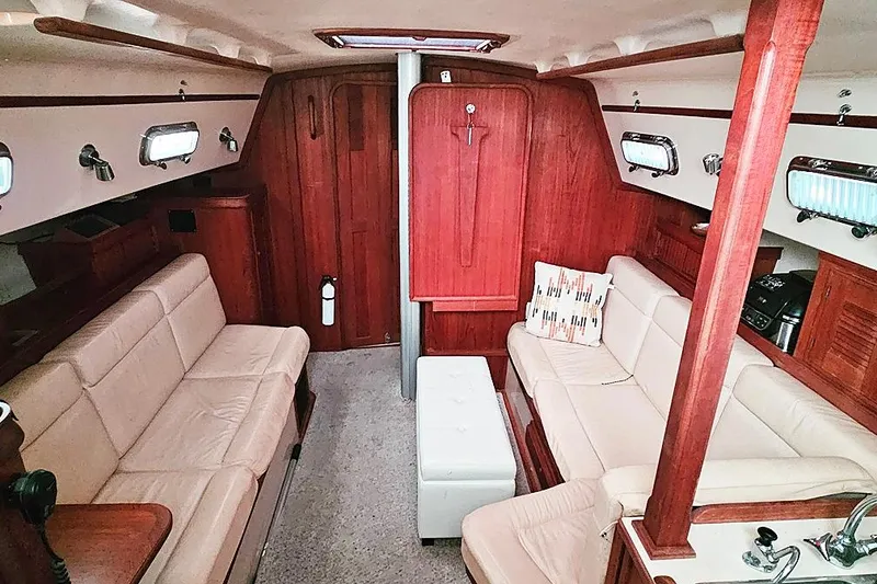 Slide: The Image of Luxurious interior of 2000 Island Packet 350 sailboat with plush seating and wood finish. - 3