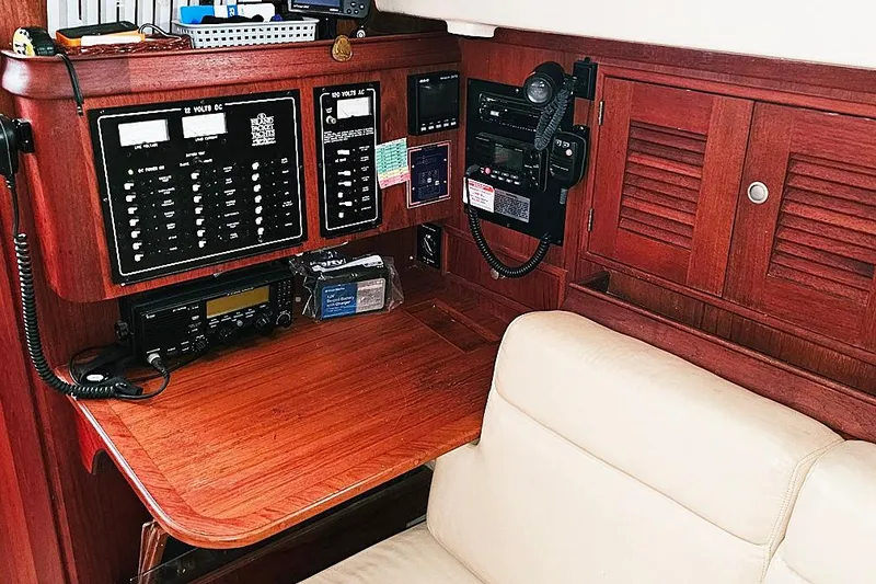 Slide: The Image of Navigation station of 2000 Island Packet 350 sailboat with control panels and communication equipment. - 8
