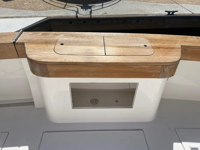 Slide: The Image of 2004 Cabo 35 Express boat with wooden deck and storage compartment. - 11