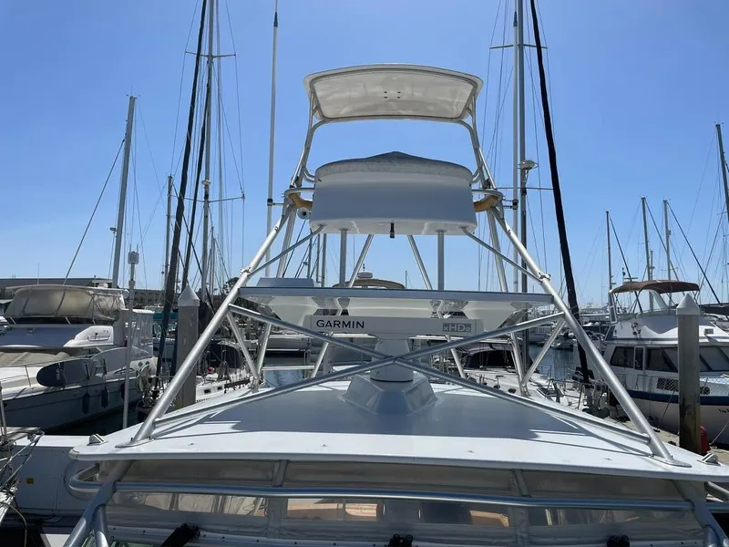 Slide: The Image of 2004 Cabo 35 Express boat docked at marina with clear blue sky. - 19