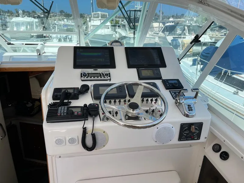 Slide: The Image of Helm of 2004 Cabo 35 Express boat with navigation equipment and controls. - 24