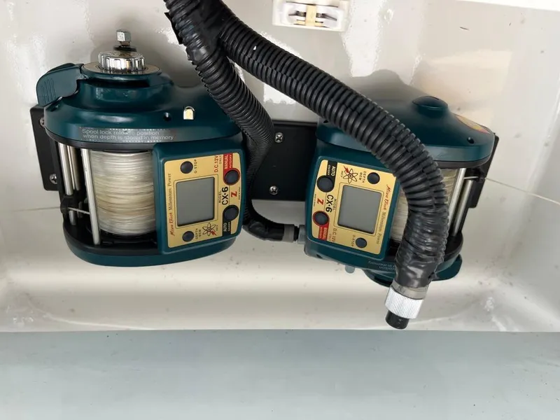 Slide: The Image of Dual electric fishing reels on a 2004 Cabo 35 Express boat. - 29
