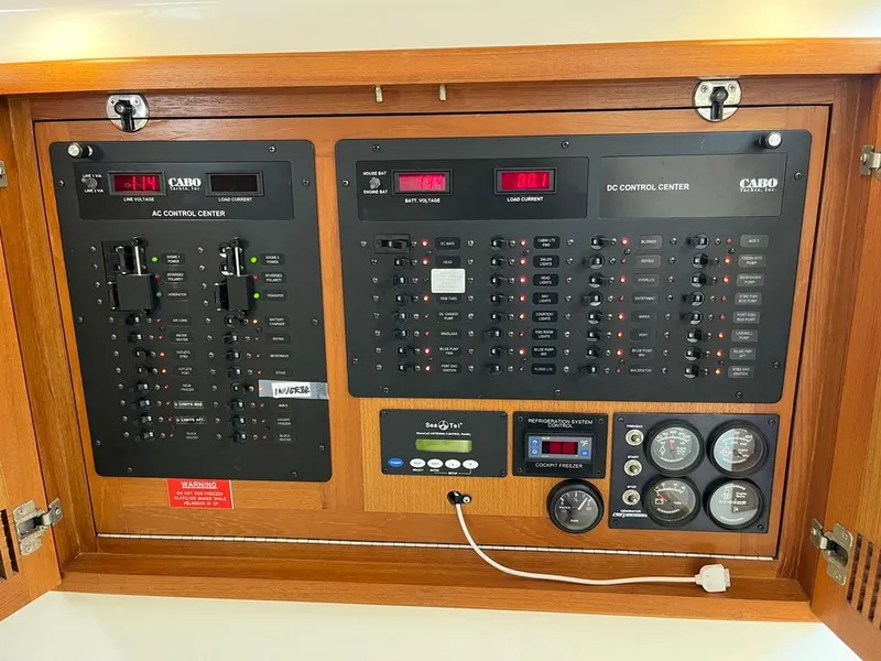 Slide: The Image of Electrical control panel of a 2004 Cabo 35 Express boat, featuring AC and DC systems. - 39