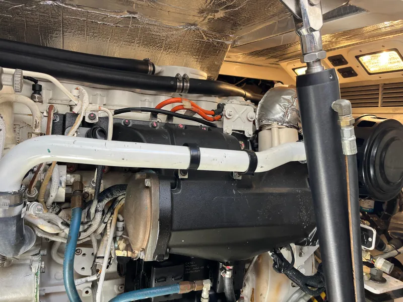 Slide: The Image of Engine compartment of a 2004 Cabo 35 Express boat, showcasing detailed mechanical components. - 41