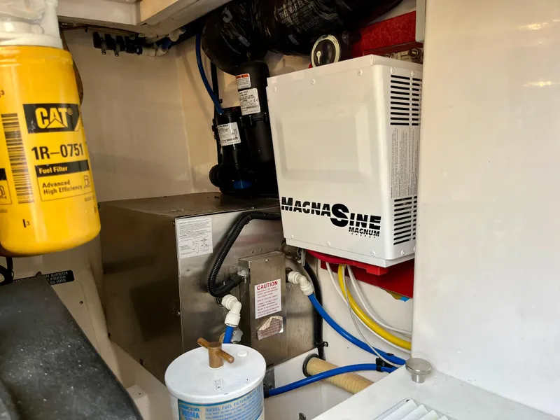 Slide: The Image of Engine room of 2004 Cabo 35 Express with fuel filter and Magnum inverter. - 45