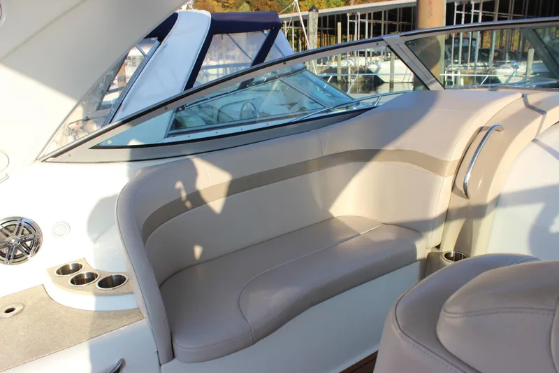 Slide: The Image of 2008 Formula 34 Performance Cruiser interior seating with beige upholstery and cup holders. - 22