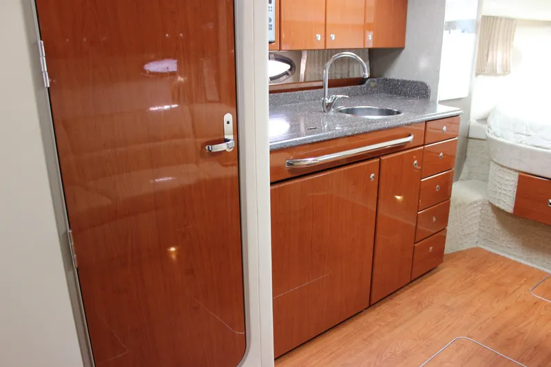 Slide: The Image of 2008 Formula 34 Performance Cruiser interior with wood cabinetry and modern kitchen amenities. - 48