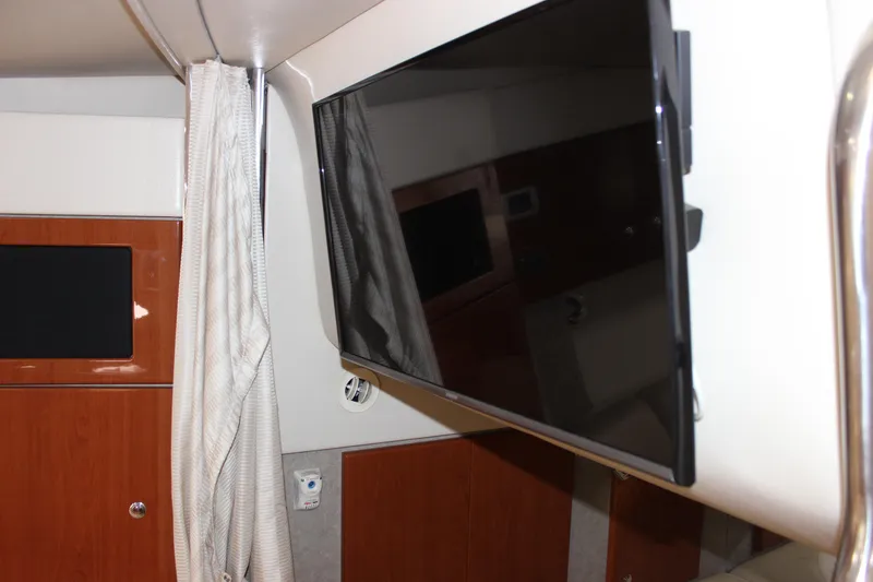 Slide: The Image of 2008 Formula 34 Performance Cruiser interior with mounted flat-screen TV and wood paneling. - 51