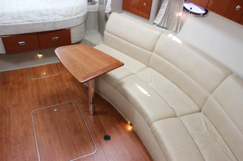 Slide: The Image of 2008 Formula 34 Performance Cruiser interior with beige leather seating and wooden table. - 53