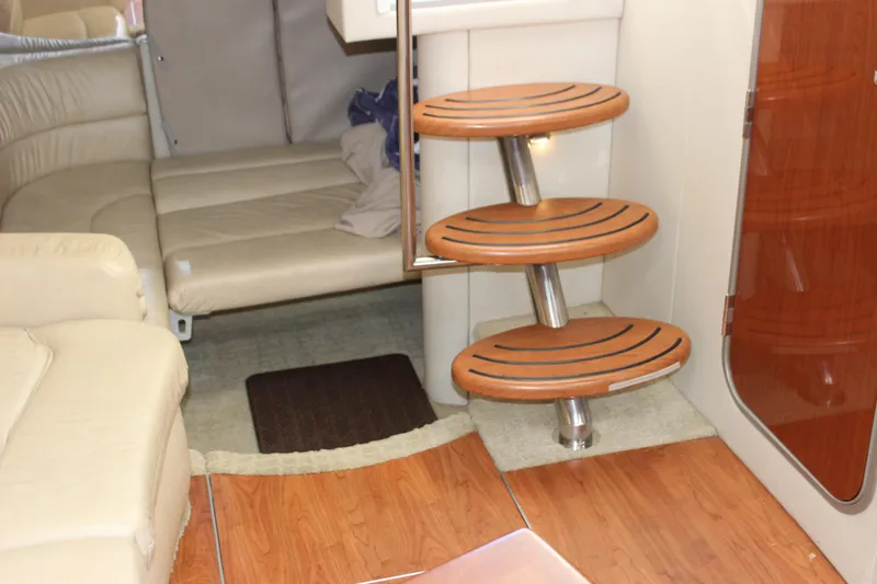 Slide: The Image of 2008 Formula 34 Performance Cruiser interior with wooden steps and beige seating. - 56