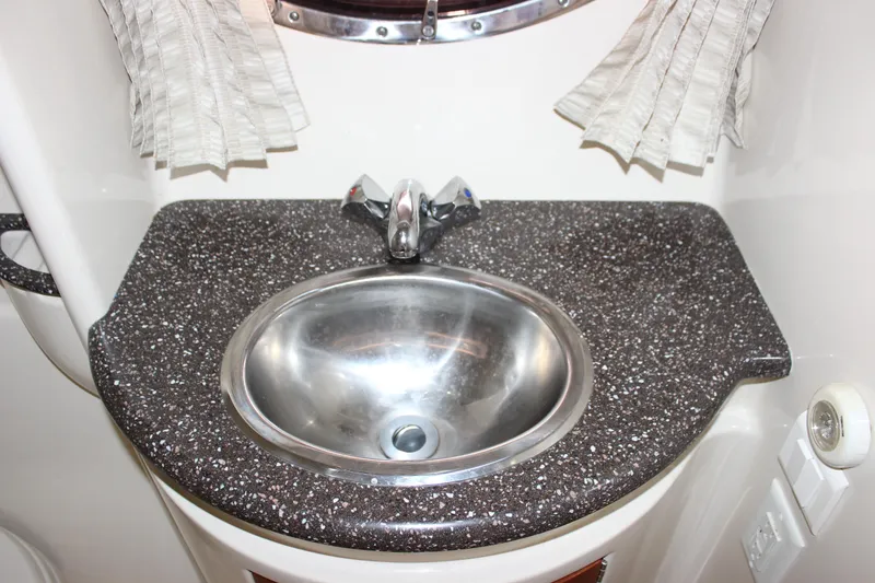 Slide: The Image of 2008 Formula 34 Performance Cruiser bathroom sink with speckled countertop and chrome faucet. - 57