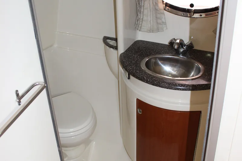 Slide: The Image of 2008 Formula 34 Performance Cruiser bathroom with sink, toilet, and porthole window. - 58
