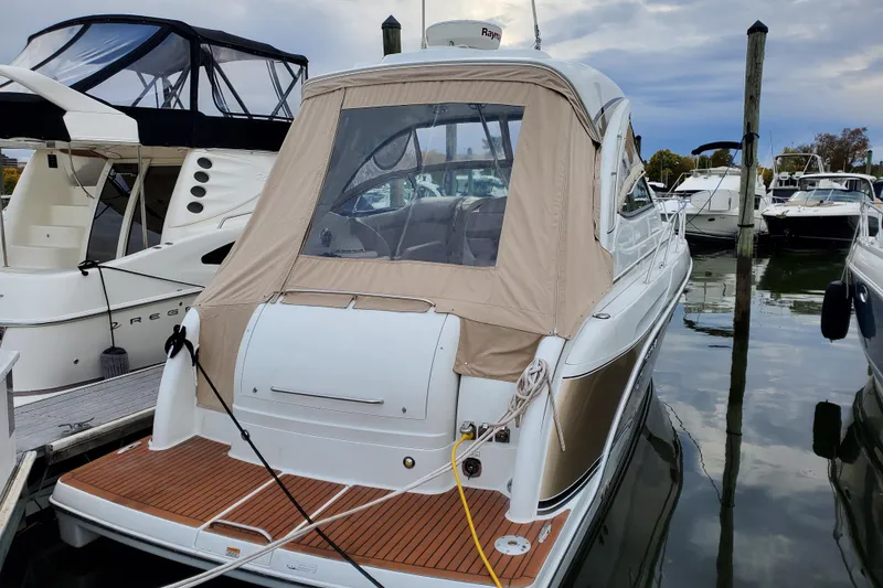 Slide: The Image of 2008 Formula 34 Performance Cruiser docked at marina, rear view with beige cover. - 65