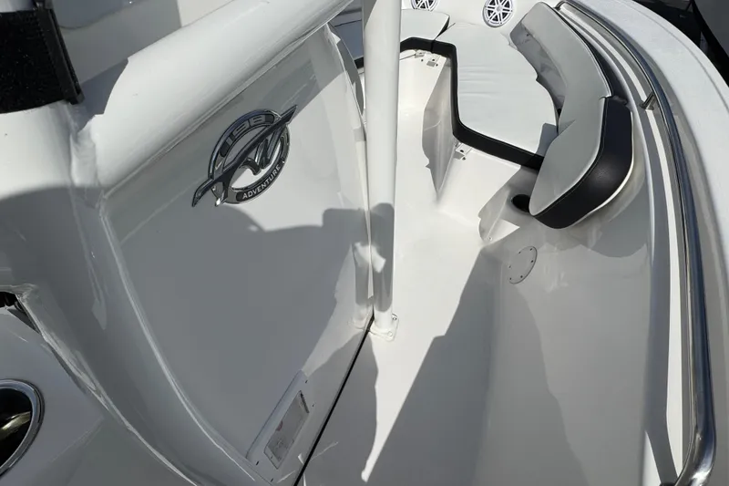 Slide: The Image of 2024 Tidewater 198 CC Adventure boat interior with seating and logo detail. - 10