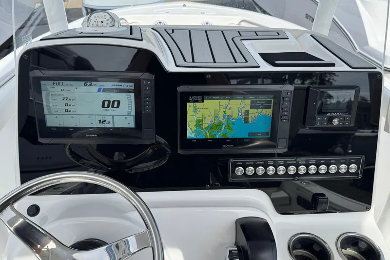 Slide: The Image of 2024 Tidewater 198 CC Adventure dashboard with Garmin displays and controls. - 19