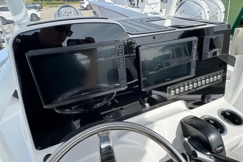 Slide: The Image of 2024 Tidewater 198 CC Adventure boat dashboard with Garmin displays and Yamaha controls. - 4
