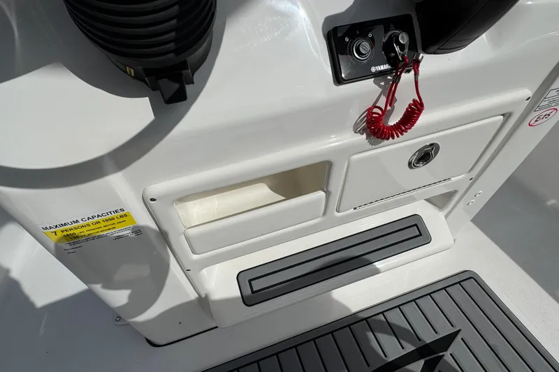 Slide: The Image of 2024 Tidewater 198 CC Adventure boat console with storage compartments and safety features. - 5