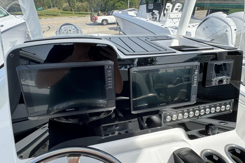 Slide: The Image of 2024 Tidewater 198 CC Adventure boat dashboard with Garmin displays and control panel. - 6