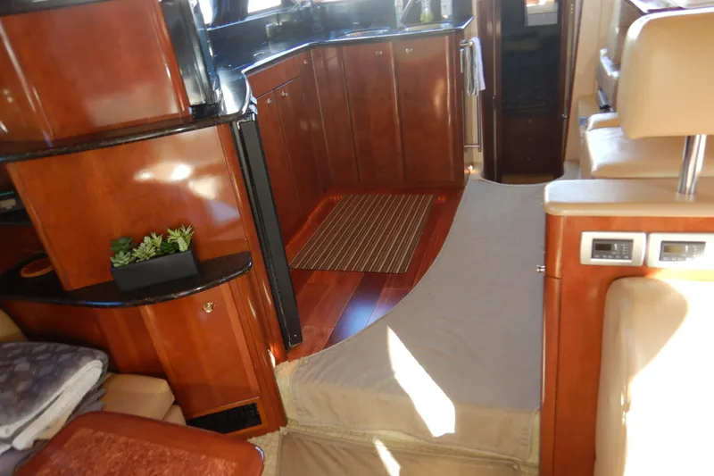 Slide: The Image of Luxurious interior of a 2008 Meridian 411 Sedan yacht with polished wood cabinetry. - 10
