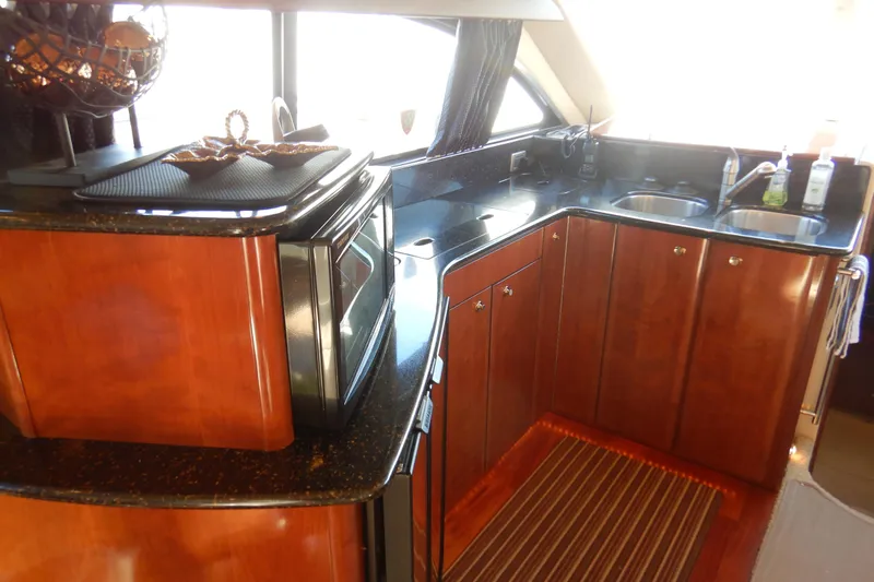 Slide: The Image of Luxurious kitchen interior of 2008 Meridian 411 Sedan yacht with wood cabinetry and modern appliances. - 11