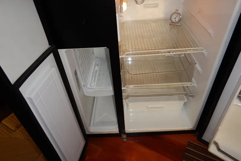 Slide: The Image of Empty refrigerator and freezer inside a 2008 Meridian 411 Sedan boat. - 12