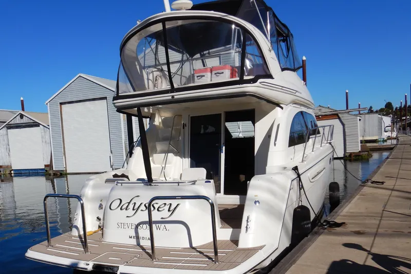 Slide: The Image of 2008 Meridian 411 Sedan yacht docked at marina under clear blue sky. - 2