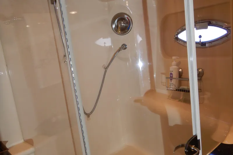 Slide: The Image of Shower area inside 2008 Meridian 411 Sedan yacht with porthole and toiletries. - 29