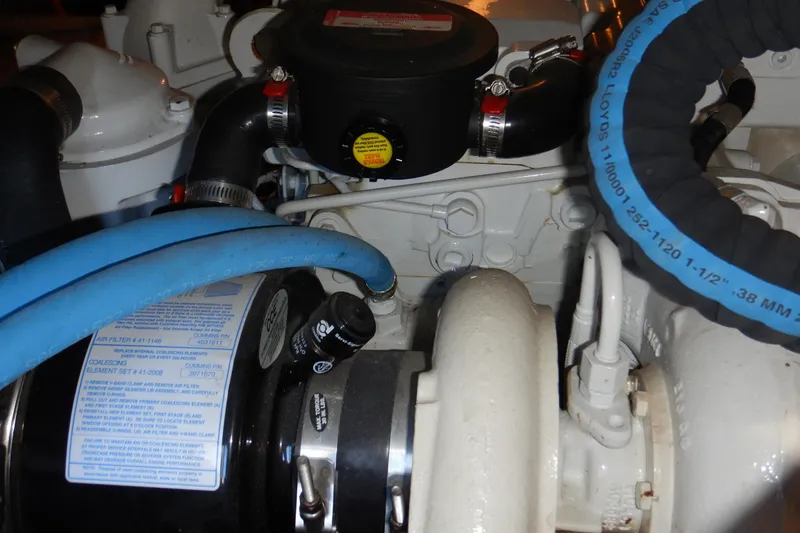 Slide: The Image of Engine components of a 2008 Meridian 411 Sedan, featuring hoses and mechanical parts. - 43