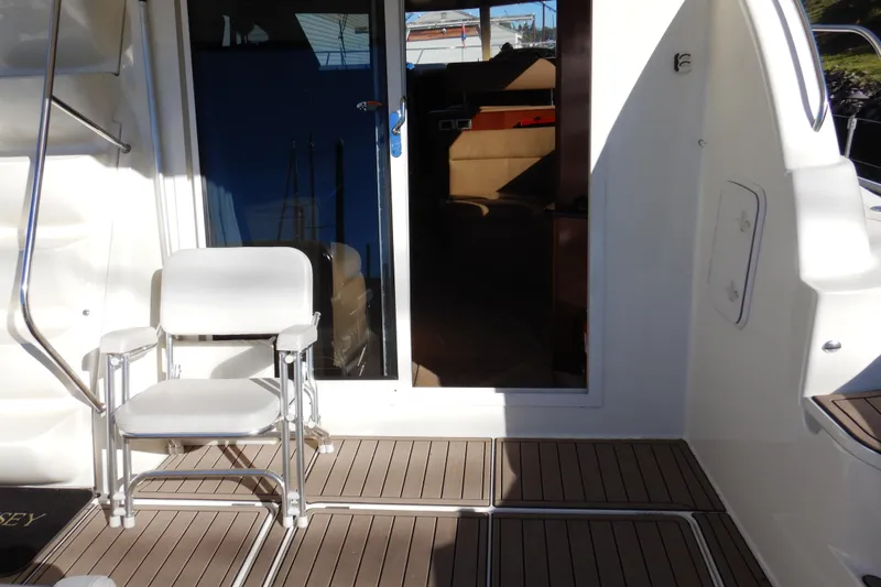 Slide: The Image of 2008 Meridian 411 Sedan yacht deck with chair and cabin entrance. - 5